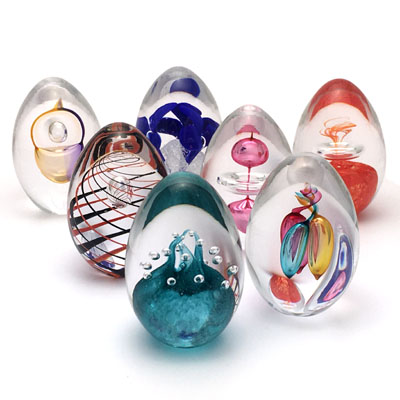 Unique Bohemia Glass pieces. Choose from an offer of several sets of coloured glass paperweights in egg shape.